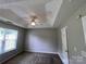 Bedroom with a tray ceiling, ceiling fan, neutral walls, and natural light at 5523 Stone Bluff Ct, Charlotte, NC 28214