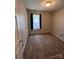 A cozy bedroom includes a window with dark curtains and neutral carpet at 5523 Stone Bluff Ct, Charlotte, NC 28214