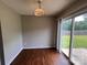 Bright dining area featuring sliding glass doors leading to the backyard and sleek, dark laminate flooring at 5523 Stone Bluff Ct, Charlotte, NC 28214