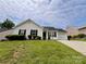 Low angle view of a single story home with green lawn at 5523 Stone Bluff Ct, Charlotte, NC 28214