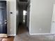 Hallway with neutral paint and carpet leading to bedrooms at 5523 Stone Bluff Ct, Charlotte, NC 28214