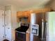 Stainless steel refrigerator and wood cabinets in Kitchen at 5523 Stone Bluff Ct, Charlotte, NC 28214