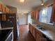 Kitchen features stainless steel refrigerator and wood cabinets at 5523 Stone Bluff Ct, Charlotte, NC 28214