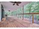 Spacious back porch with wood floors, railings, and a view of the backyard hammock at 5611 Charter Oaks Ln, York, SC 29745