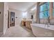 Bright bathroom with a modern tub, double sinks, and natural light from the window at 5611 Charter Oaks Ln, York, SC 29745
