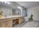Large bathroom featuring double sinks, a freestanding tub, and natural wood cabinetry at 5611 Charter Oaks Ln, York, SC 29745