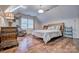 Bright bedroom with hardwood floors, a comfortable chair, and a stylishly decorated bed at 5611 Charter Oaks Ln, York, SC 29745
