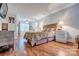 Bright bedroom featuring a large bed, hardwood floors, and a vintage dresser at 5611 Charter Oaks Ln, York, SC 29745