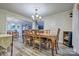 Formal dining room with beautiful natural-wood furniture, access to the kitchen, and hardwood style flooring at 5611 Charter Oaks Ln, York, SC 29745