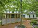 Beautiful two-story white home with black trim, large front porch, and lush landscaping at 5611 Charter Oaks Ln, York, SC 29745