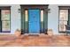 Close up of front door with black trim, blue door, and pot plants flanking either side at 5611 Charter Oaks Ln, York, SC 29745