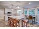Bright kitchen features modern appliances, marble counters, pendant lighting, an island with seating, and a breakfast nook at 5611 Charter Oaks Ln, York, SC 29745