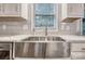 Farmhouse style stainless steel sink, white quartz countertops and subway tile backsplash at 5611 Charter Oaks Ln, York, SC 29745