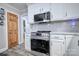 Renovated kitchen featuring stainless steel appliances, white countertops, and gray backsplash at 5611 Charter Oaks Ln, York, SC 29745
