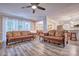Spacious living room features hardwood style floors, large windows with natural light, and open access to the dining area at 5611 Charter Oaks Ln, York, SC 29745