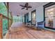 Covered porch with wooden floors and ceiling fans, furnished with chairs and a table at 5611 Charter Oaks Ln, York, SC 29745
