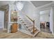 Traditional staircase with wooden treads, white risers and spindles, custom lighting, and hardwood flooring at 5611 Charter Oaks Ln, York, SC 29745
