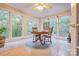 Cozy sunroom with views of the wooded surroundings, white-tile flooring, a ceiling fan, and lots of natural light at 5611 Charter Oaks Ln, York, SC 29745