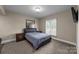 Bedroom featuring carpeted floors, a window with blinds, and a queen-sized bed at 6017 Sierra Dr, Charlotte, NC 28216
