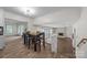Open-concept space featuring dining area with fireplace and seamless flow to adjoining living area at 6017 Sierra Dr, Charlotte, NC 28216