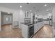 Updated kitchen with white cabinets, stainless steel appliances and large island with wine cooler at 6017 Sierra Dr, Charlotte, NC 28216