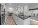 Spacious kitchen with stainless steel appliances, white cabinets and expansive dark countertop island at 6017 Sierra Dr, Charlotte, NC 28216
