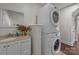 Laundry room featuring stacked washer/dryer and a single sink vanity with a small mirror at 6017 Sierra Dr, Charlotte, NC 28216
