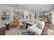 Virtually staged living room with hardwood floors, built-in bookcase and neutral sectional sofa at 6017 Sierra Dr, Charlotte, NC 28216