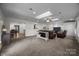 Bright living room with carpet, skylight, leather seating and view into the dining area at 6017 Sierra Dr, Charlotte, NC 28216