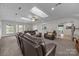 Bright living room with carpet, ceiling fan, skylight, and leather furniture at 6017 Sierra Dr, Charlotte, NC 28216