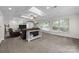Bright living room featuring a skylight, large windows, and comfortable seating at 6017 Sierra Dr, Charlotte, NC 28216