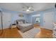 Bedroom featuring wood floors, a ceiling fan, and a stylish gray bed at 6017 Sierra Dr, Charlotte, NC 28216