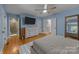 Spacious bedroom with wood floors, ceiling fan, walk-in shower and stylish decor at 6017 Sierra Dr, Charlotte, NC 28216
