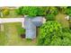 Aerial view of the property showcasing the house, yard, patio, and surrounding trees at 613 Poplar Dr, Shelby, NC 28152