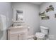Modern bathroom with updated vanity, granite countertops, and decorative floating shelves at 613 Poplar Dr, Shelby, NC 28152