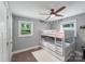 A cozy bedroom featuring a bunk bed, ceiling fan, and natural light from the windows at 613 Poplar Dr, Shelby, NC 28152