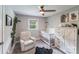 Cozy Bedroom with a comfortable chair, crib, ceiling fan, and decorative accents at 613 Poplar Dr, Shelby, NC 28152