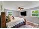 Bedroom with large TV, ceiling fan, and bright windows at 613 Poplar Dr, Shelby, NC 28152