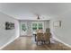 Bright dining area featuring modern light fixture, wood-look floors, a neutral color palette and natural light at 613 Poplar Dr, Shelby, NC 28152
