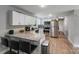 Well-lit kitchen with stainless steel appliances, granite countertops, and modern white cabinets at 613 Poplar Dr, Shelby, NC 28152
