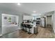 Open concept kitchen featuring a breakfast bar, stainless steel appliances, and wood-look flooring at 613 Poplar Dr, Shelby, NC 28152