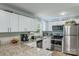 Updated kitchen with stainless steel appliances, granite countertops, and bright white cabinetry at 613 Poplar Dr, Shelby, NC 28152