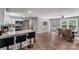 Open-concept kitchen and dining area with granite countertops, stainless steel appliances, and hardwood floors at 613 Poplar Dr, Shelby, NC 28152