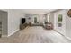 Inviting living room with neutral tones, plush carpeting, and abundant natural light from large windows at 613 Poplar Dr, Shelby, NC 28152