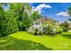 Spacious backyard featuring lush lawn, mature trees, and a deck for outdoor enjoyment at 701 Larkridge Ct, Rock Hill, SC 29730
