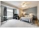 Comfortable bedroom with neutral walls, a ceiling fan, a window, and soft carpet at 701 Larkridge Ct, Rock Hill, SC 29730
