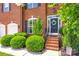 Inviting entrance showcases a wreath on the front door, manicured bushes, and brick steps at 701 Larkridge Ct, Rock Hill, SC 29730
