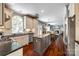 Open kitchen featuring an island, granite countertops, stainless steel appliances, and hardwood floors at 701 Larkridge Ct, Rock Hill, SC 29730