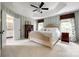 Bright main bedroom with a tray ceiling, carpet, and en suite bathroom at 701 Larkridge Ct, Rock Hill, SC 29730