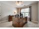 Home office with a large wooden desk, neutral carpet, and natural light from the window at 701 Larkridge Ct, Rock Hill, SC 29730